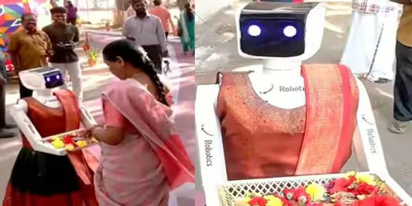 கோவையில் வாக்குச்சாவடியில் வாக்காளர்களை இனிப்பு கொடுத்து வரவேற்கும் ரோபோ!
